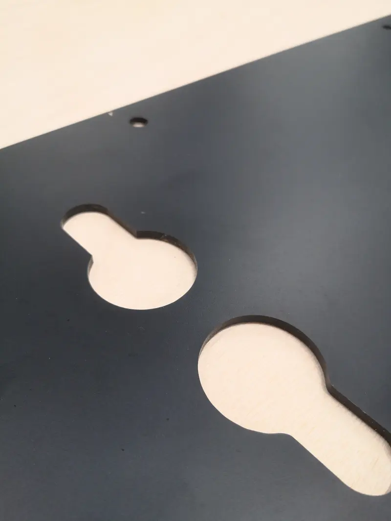 Dark panel with routed keyhole cut-outs