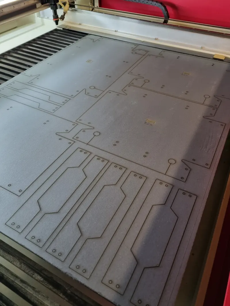 Sheet of laser-cut panel parts on the laser bed